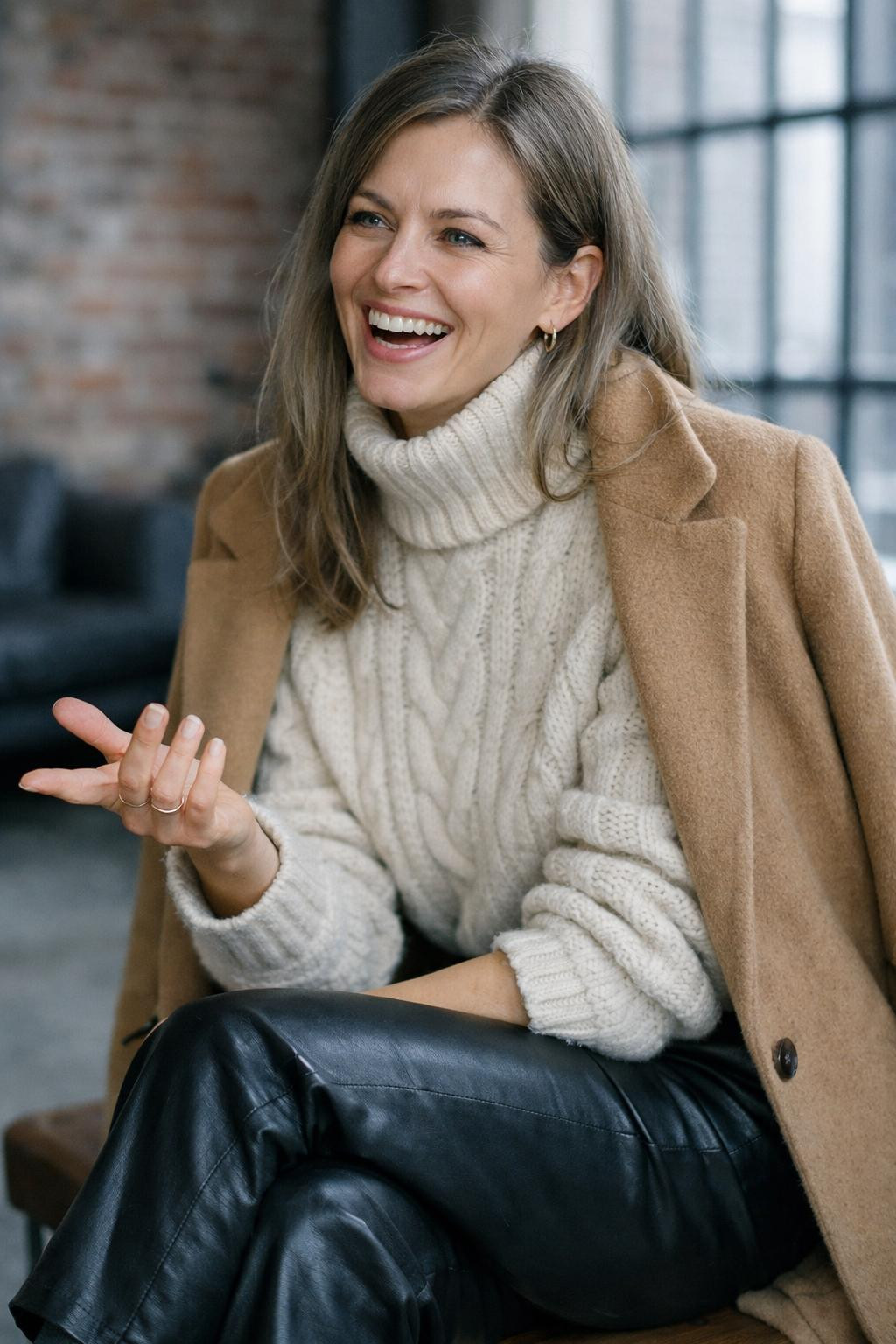 Winter birthday outfit with cream cable-knit sweater and black leather pants