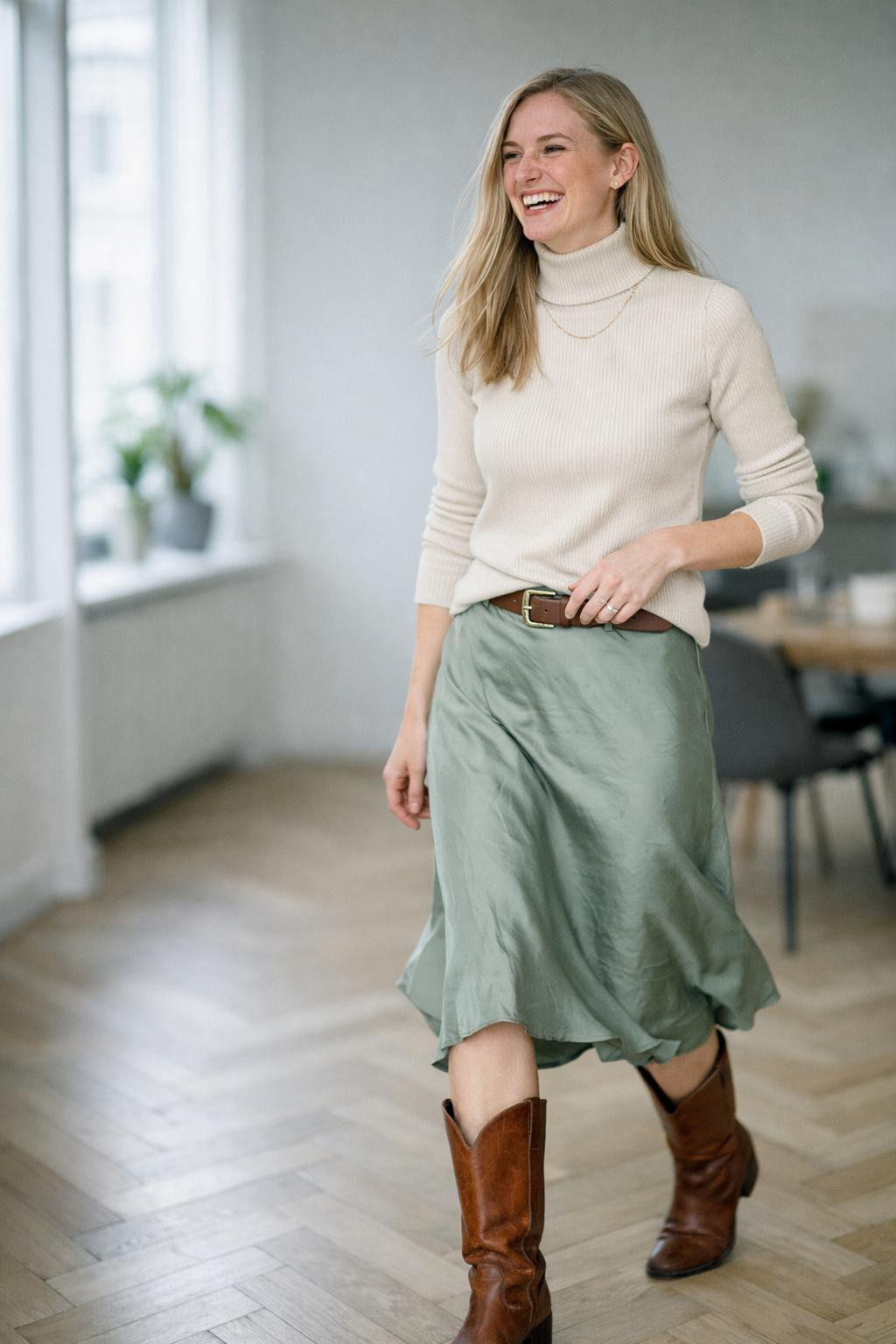 Cowboy boots outfit with cream turtleneck and sage slip skirt