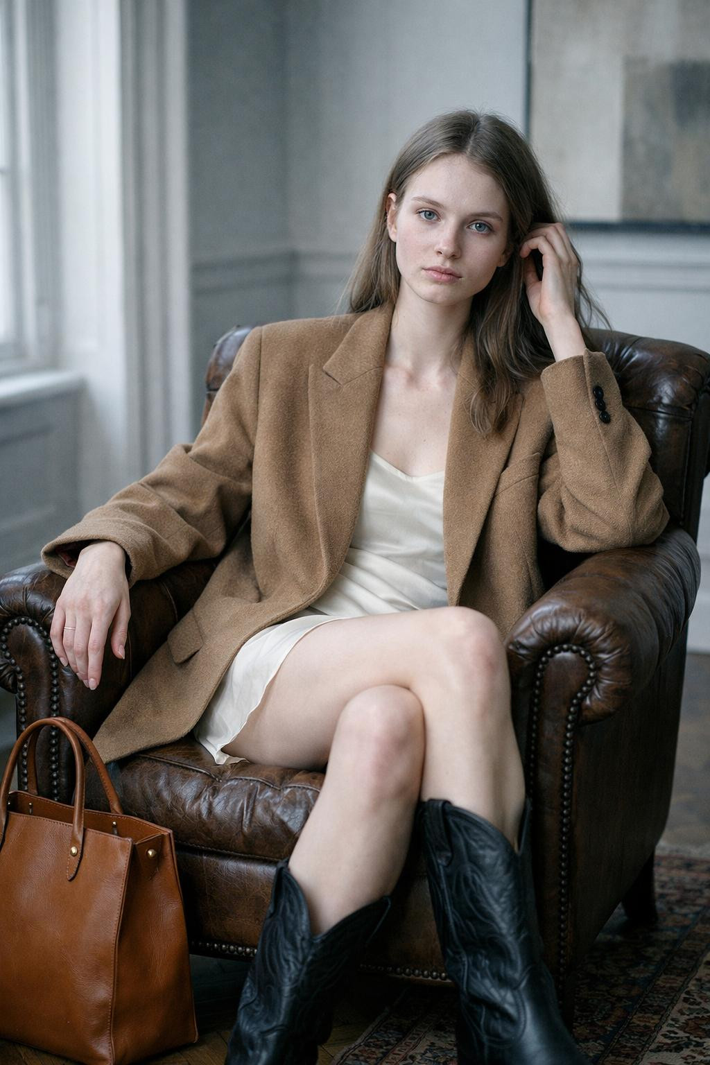 Cowboy boots outfit with camel blazer and black pointed-toe cowboy boots