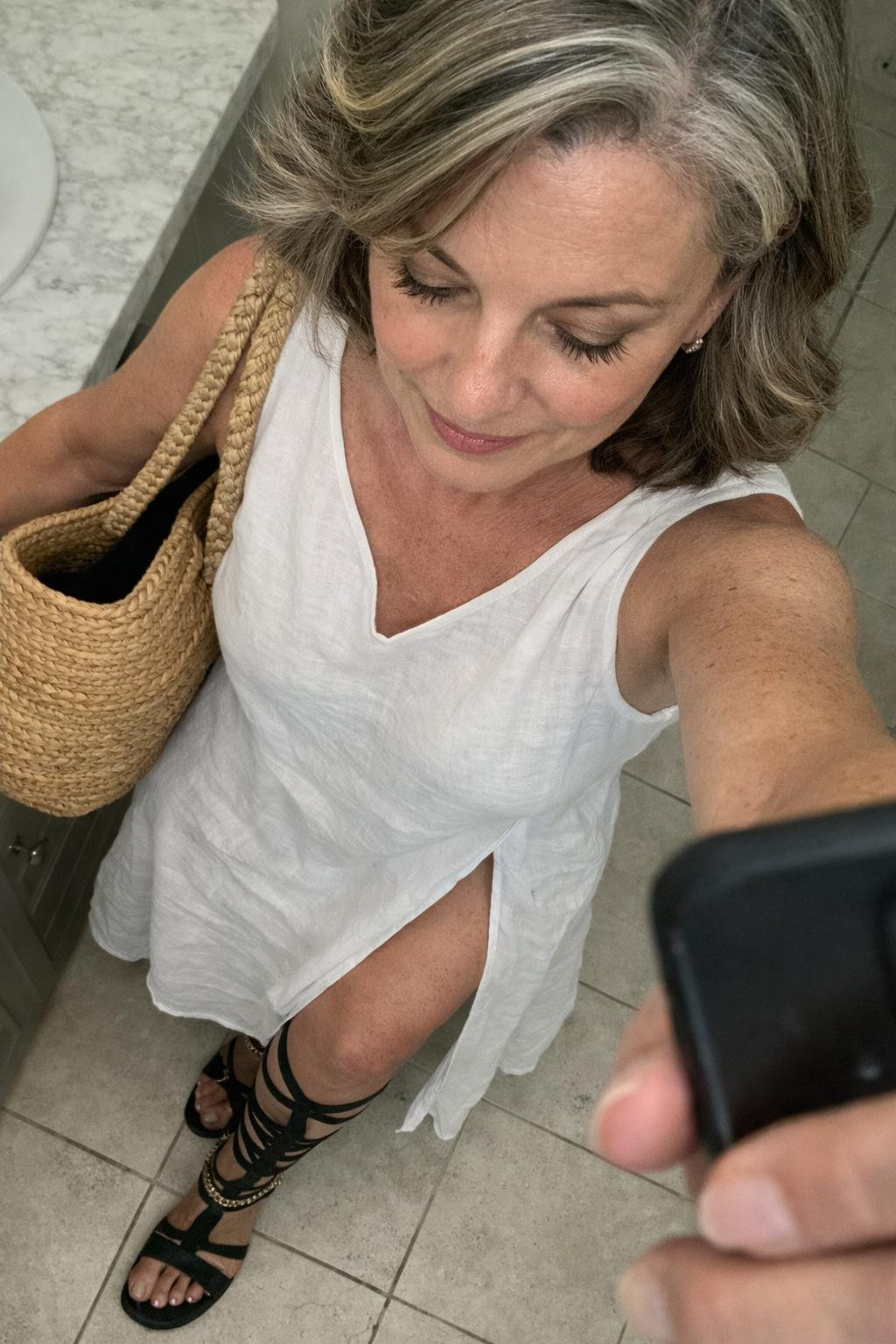Gladiator sandals with multiple calf straps and white maxi dress