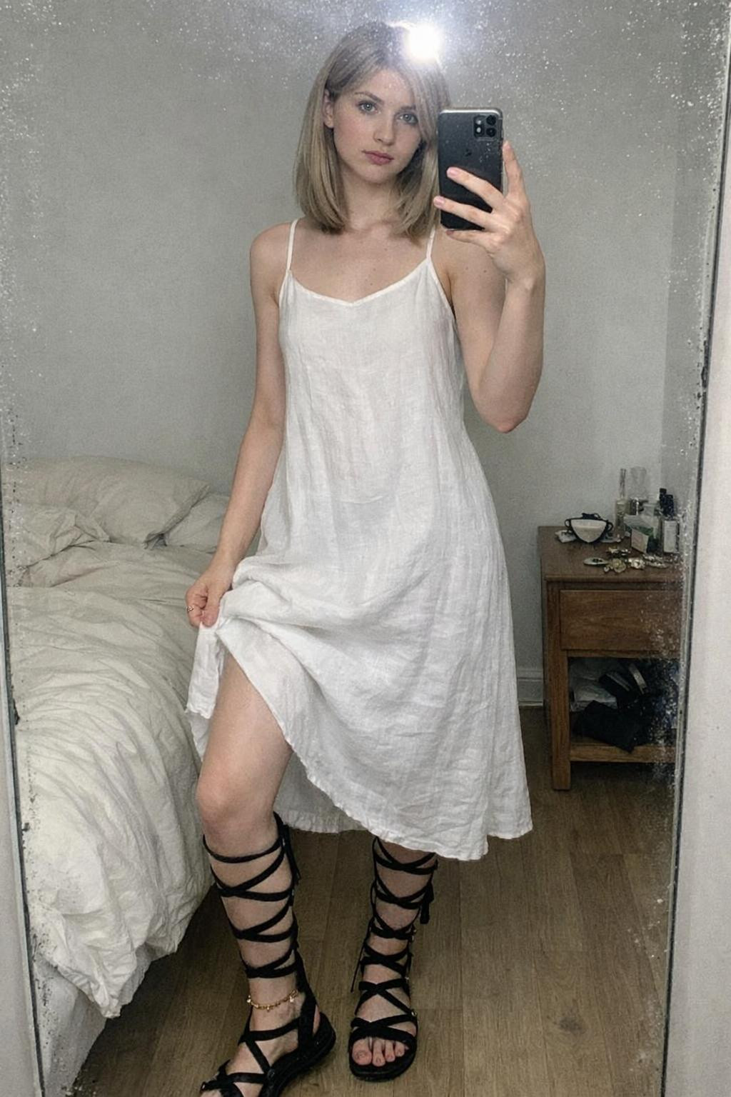 Gladiator sandals with multiple strappy bands and white linen dress