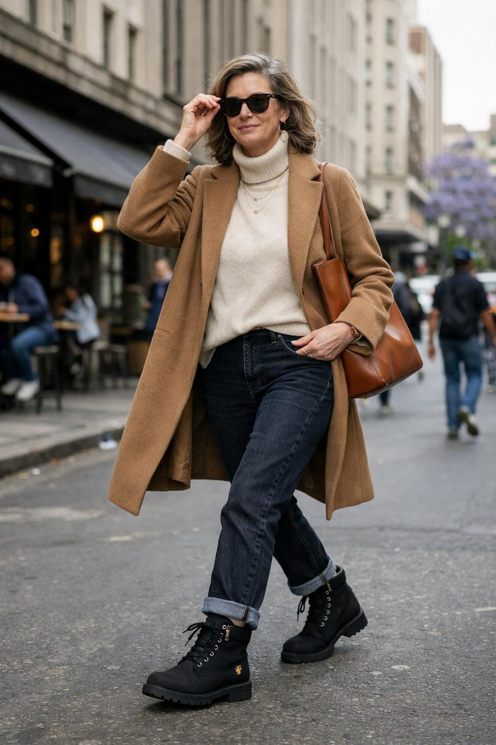 Black Timberland boots outfit with camel coat and dark jeans