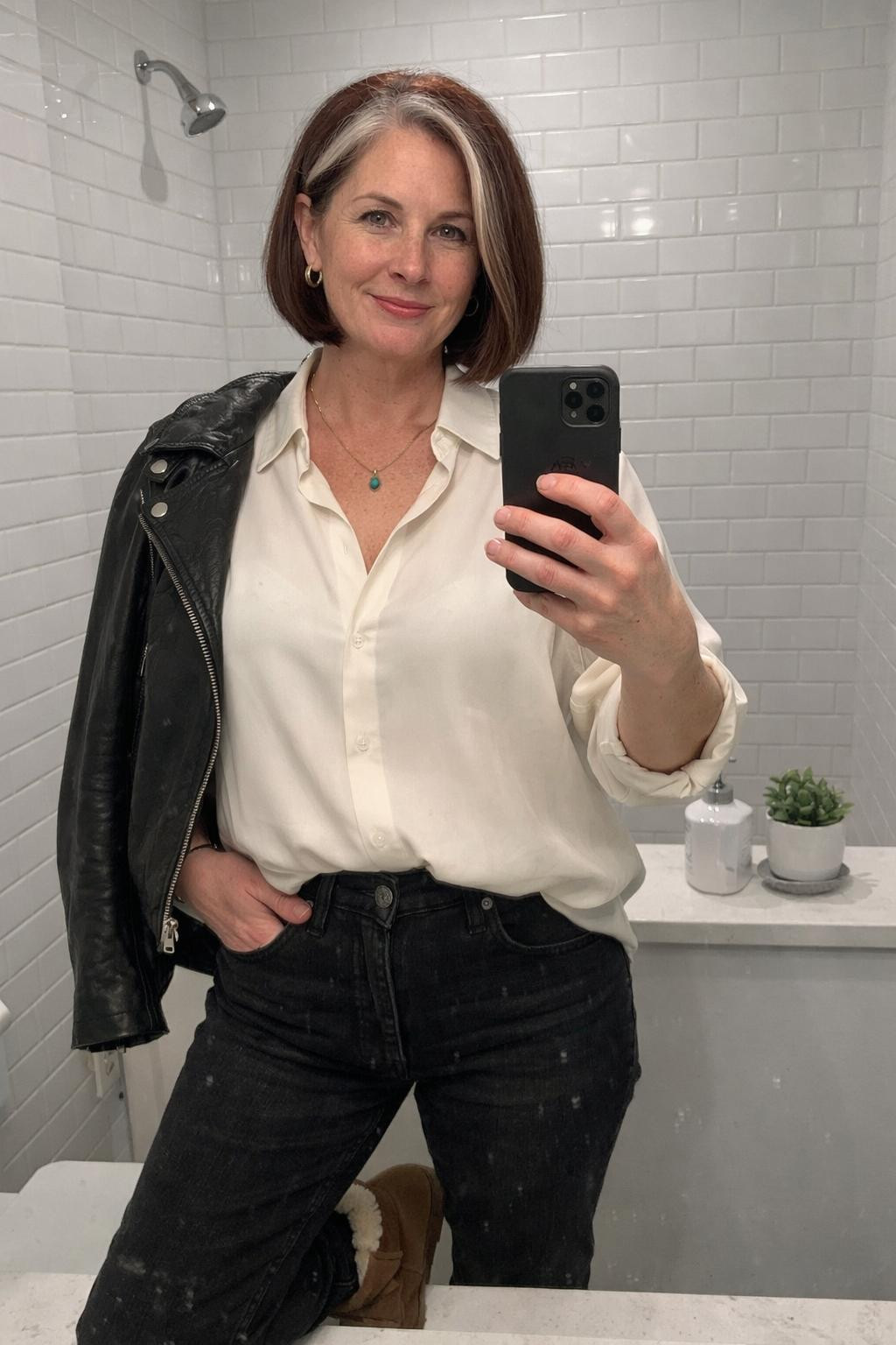 Outfits with Ugg boots styled with black jeans and ivory silk blouse