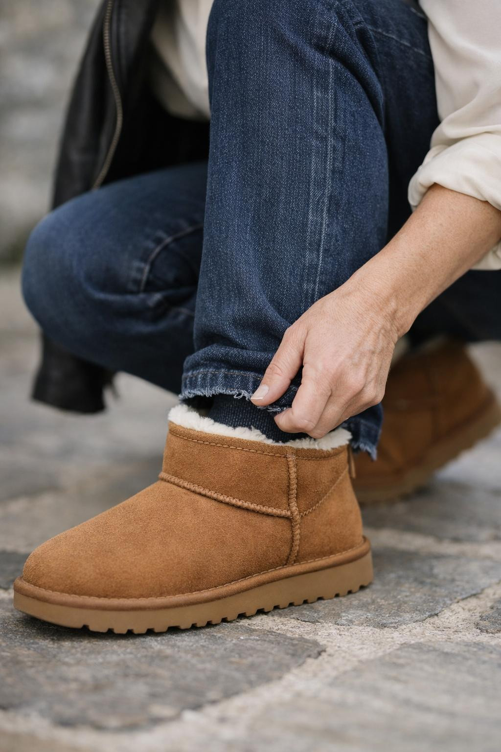 Outfits with Ugg boots showcasing tucked jeans and sheepskin collar detail