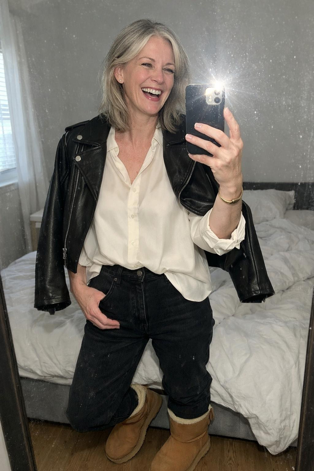 Outfits with Ugg boots featuring black jeans and leather moto jacket