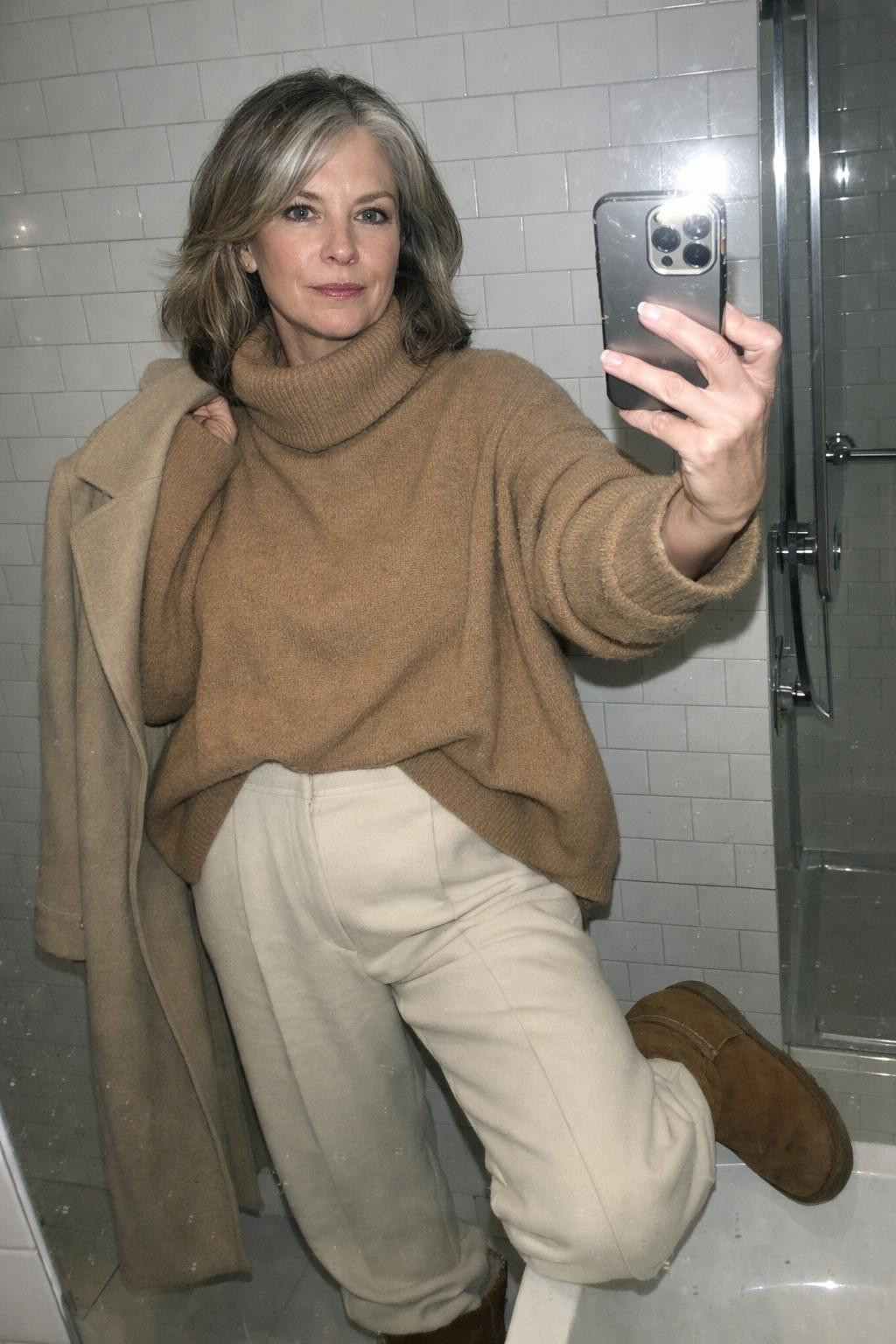 Outfits with Ugg boots featuring wide-leg trousers and camel coat