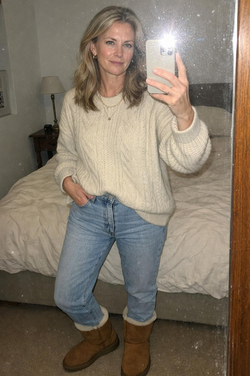 Outfits with Ugg boots styled with cream sweater and light-wash denim