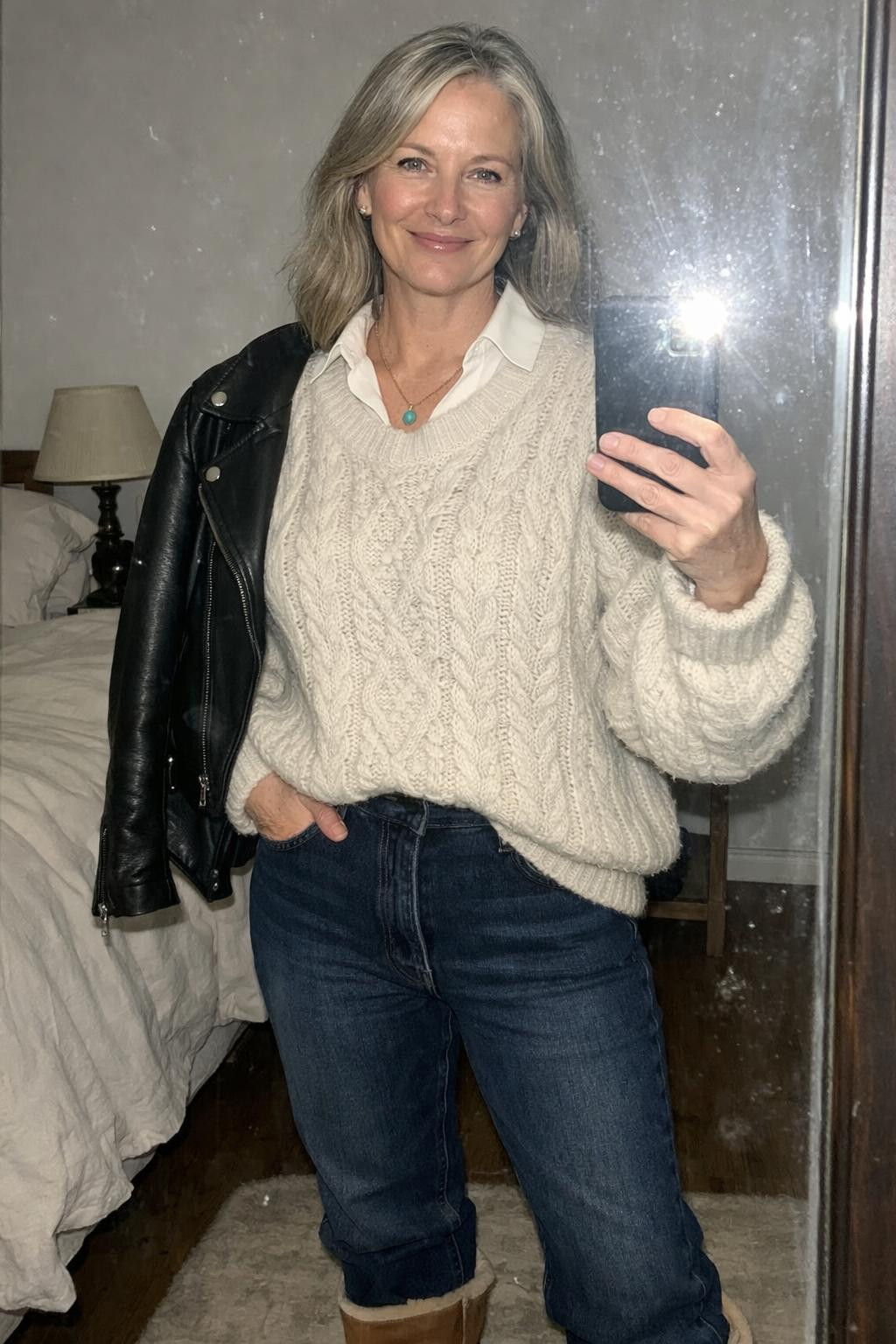 Outfits with Ugg boots featuring oversized cream sweater and dark jeans