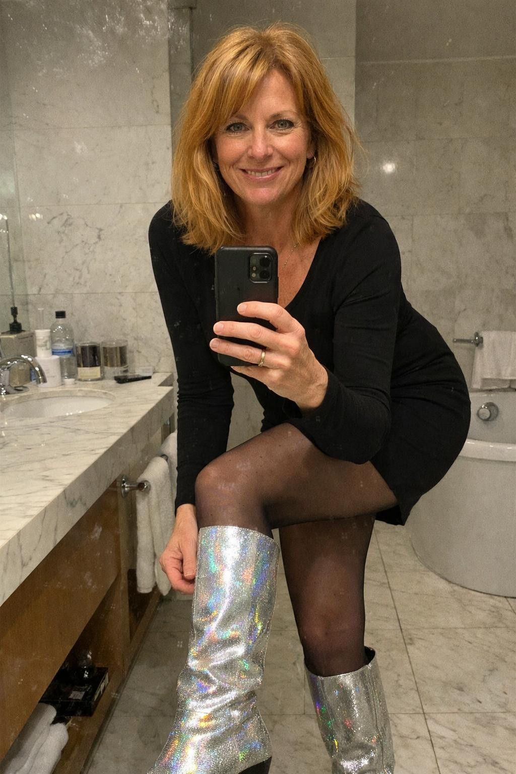 Sparkly boots outfit with silver metallic knee-high boots and black dress