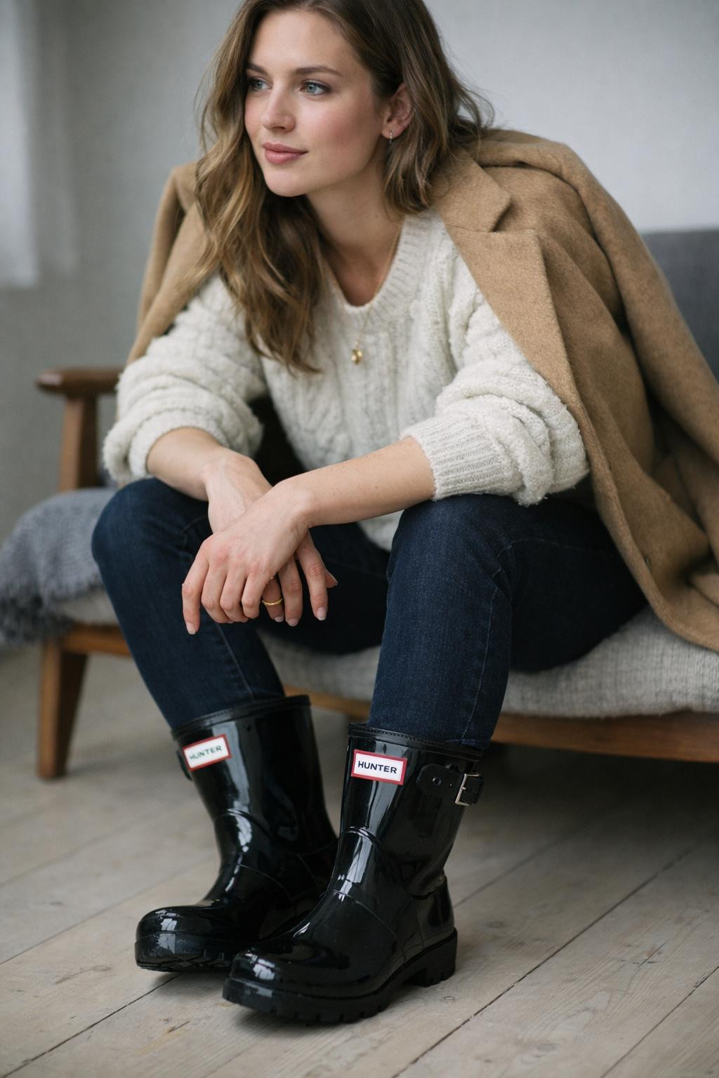Short hunter boots outfit seated pose with apartment interior