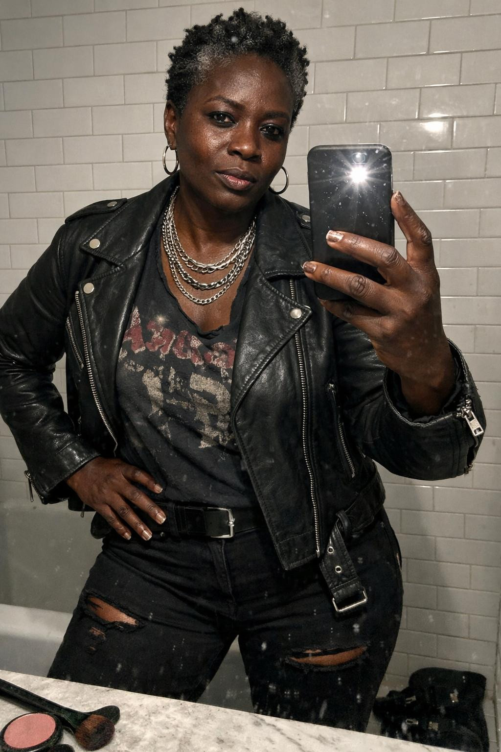 Concert outfit black women featuring grey streaks in natural hair and leather jacket