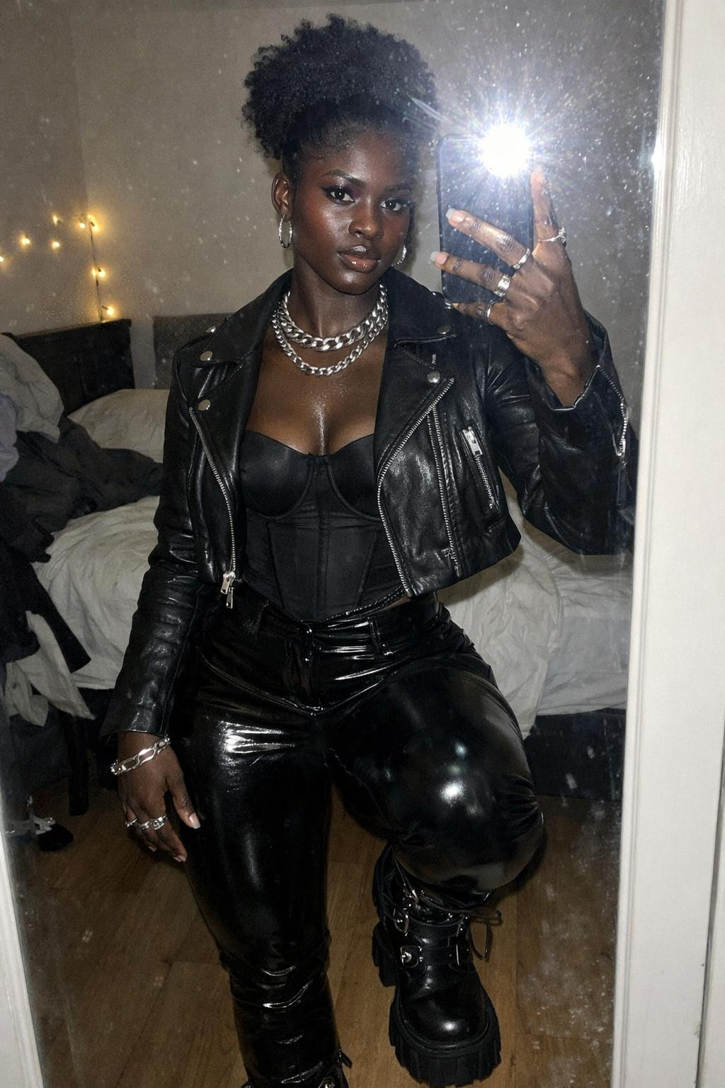 Concert outfit black women featuring platform combat boots and high puff hairstyle