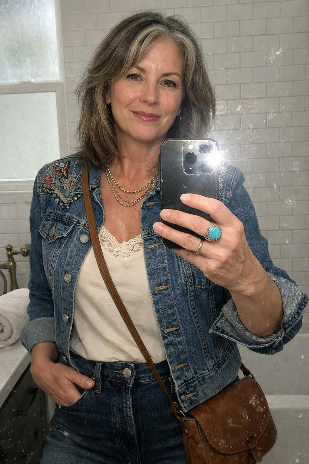 Country concert outfit ideas with embroidered denim jacket and lace camisole