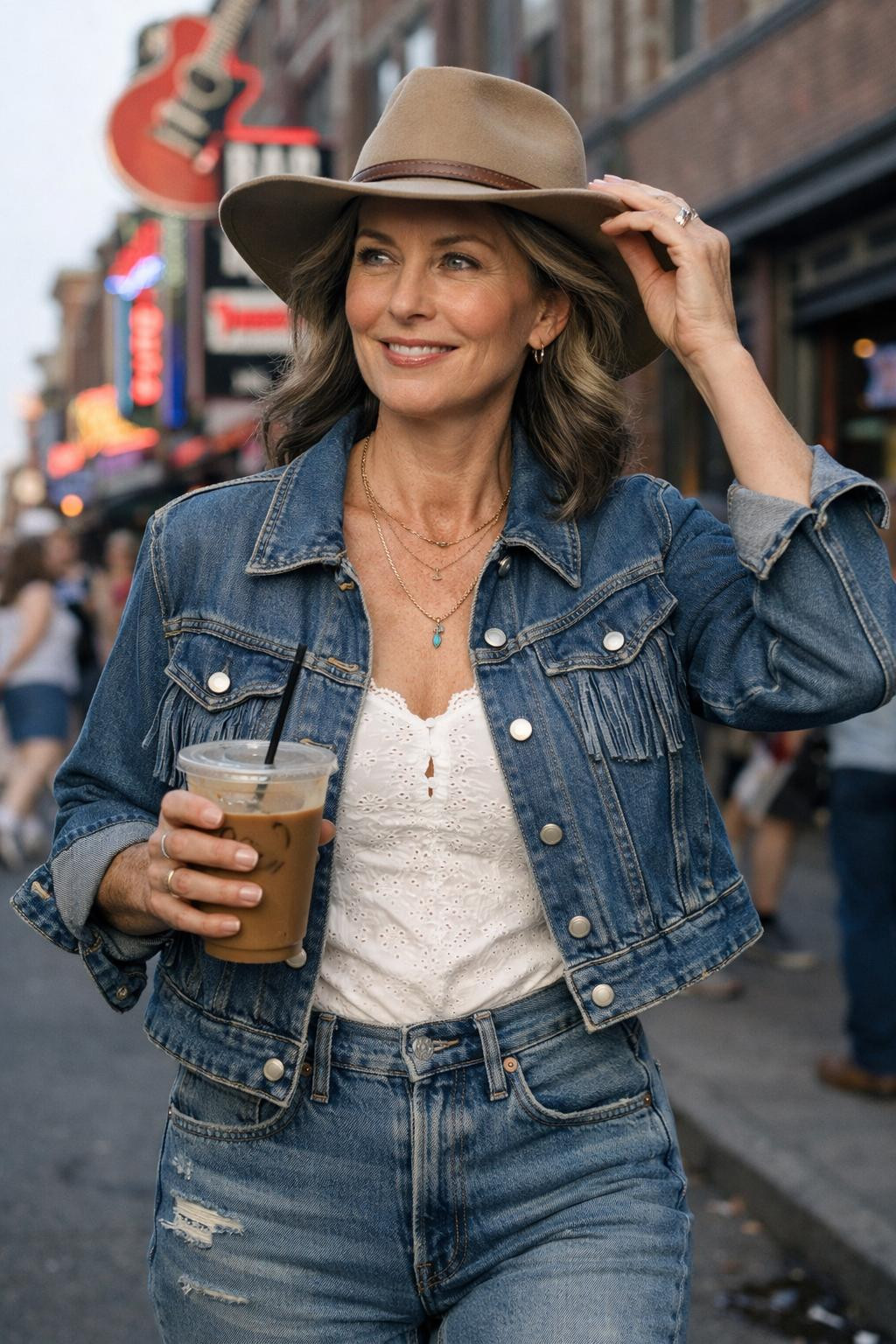 Country concert outfit ideas with vintage denim jacket and white lace bodysuit