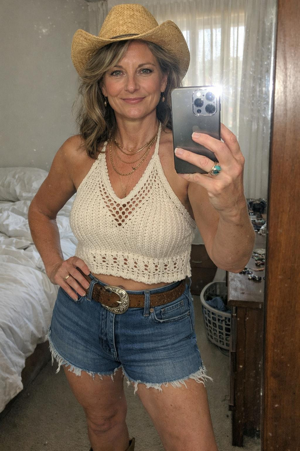 Country concert outfit ideas with cream crochet halter top and denim shorts