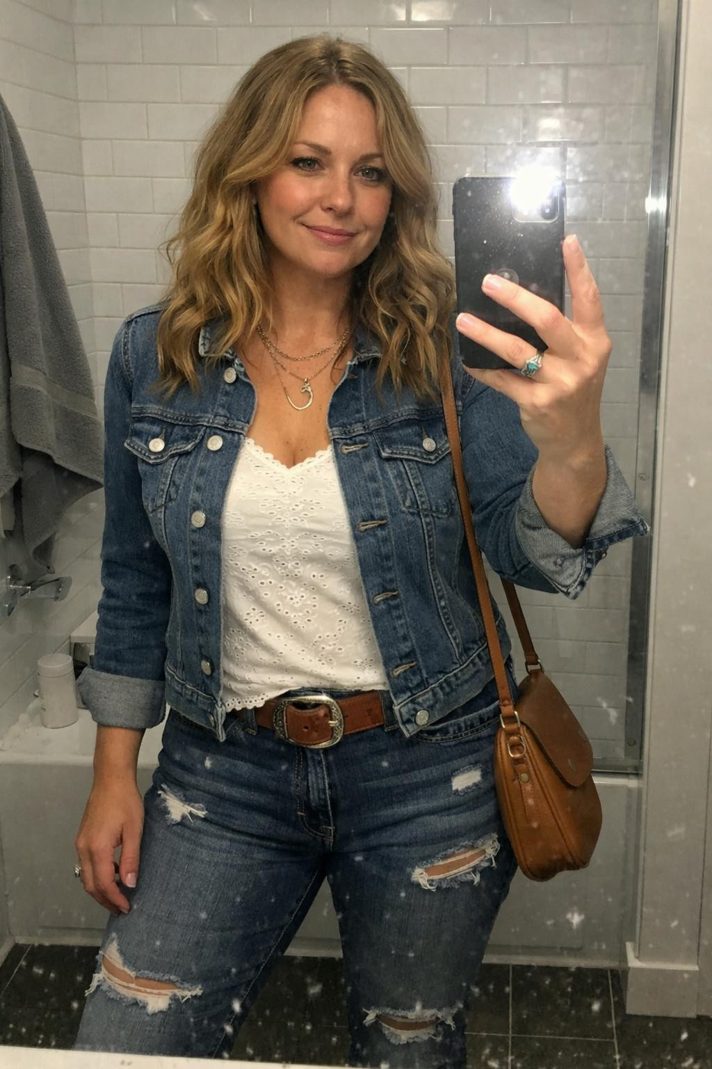 Country concert outfit ideas with fitted denim jacket and white lace tank