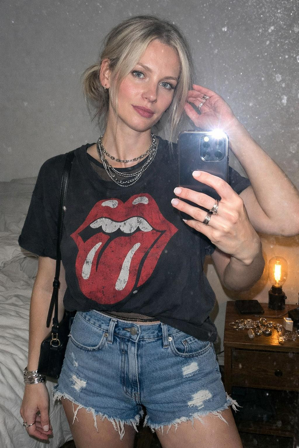 Summer concert outfit with black mesh crop top under vintage band tee and combat boots