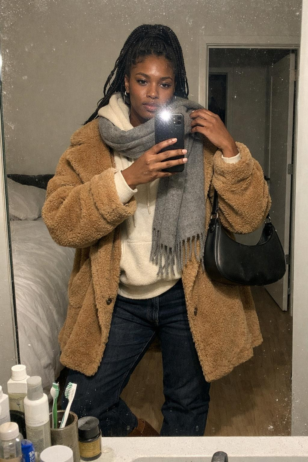 Winter concert outfit on Black woman with box braids and teddy coat