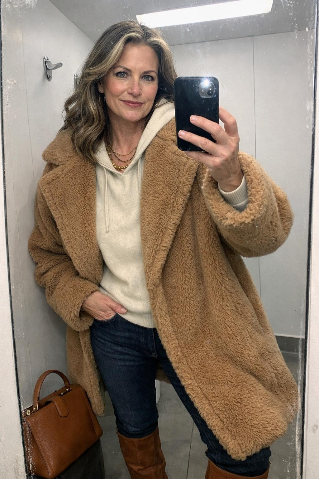 Winter concert outfit with camel teddy coat and cream cashmere hoodie