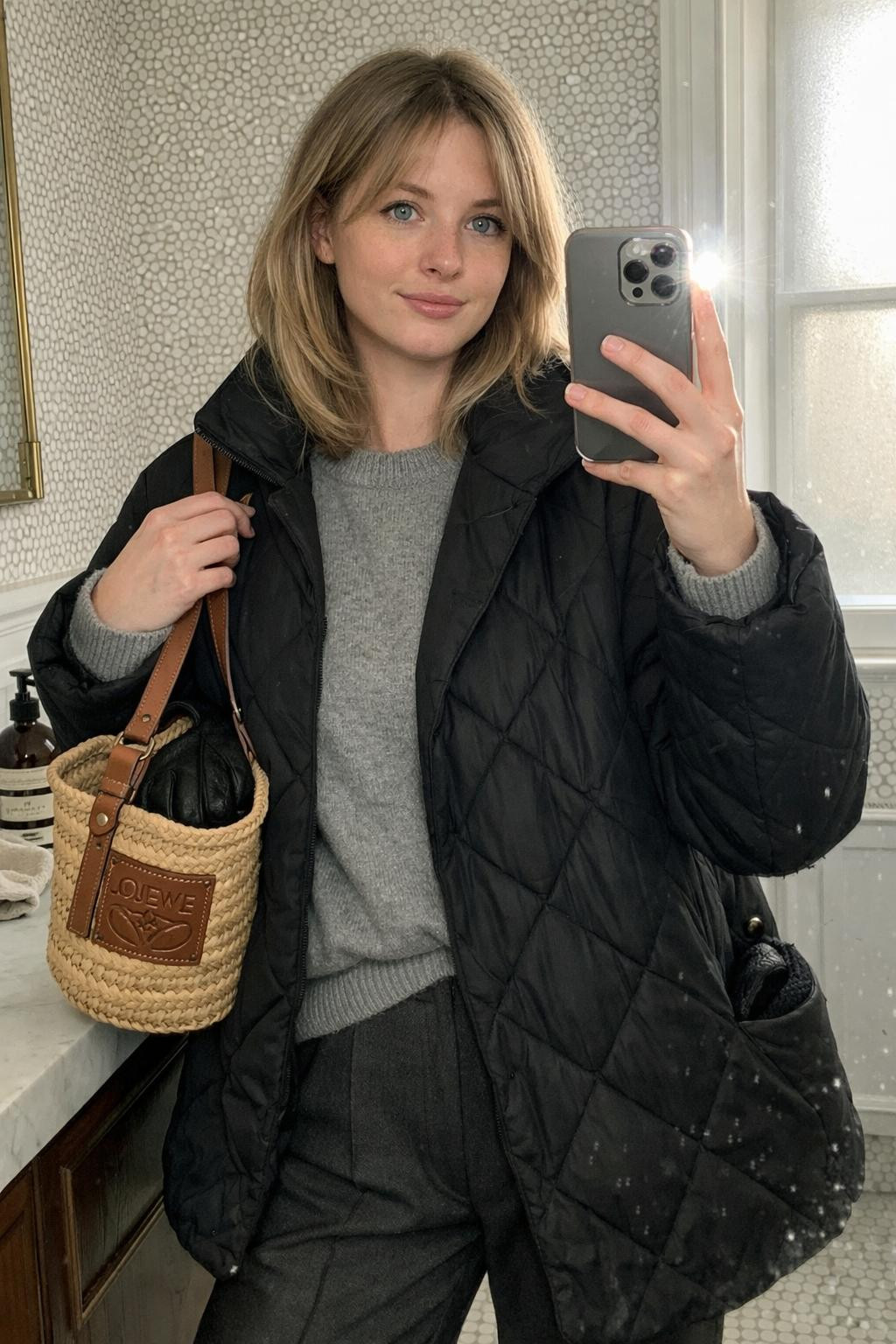 Cozy airport outfit bathroom selfie with brass fixtures