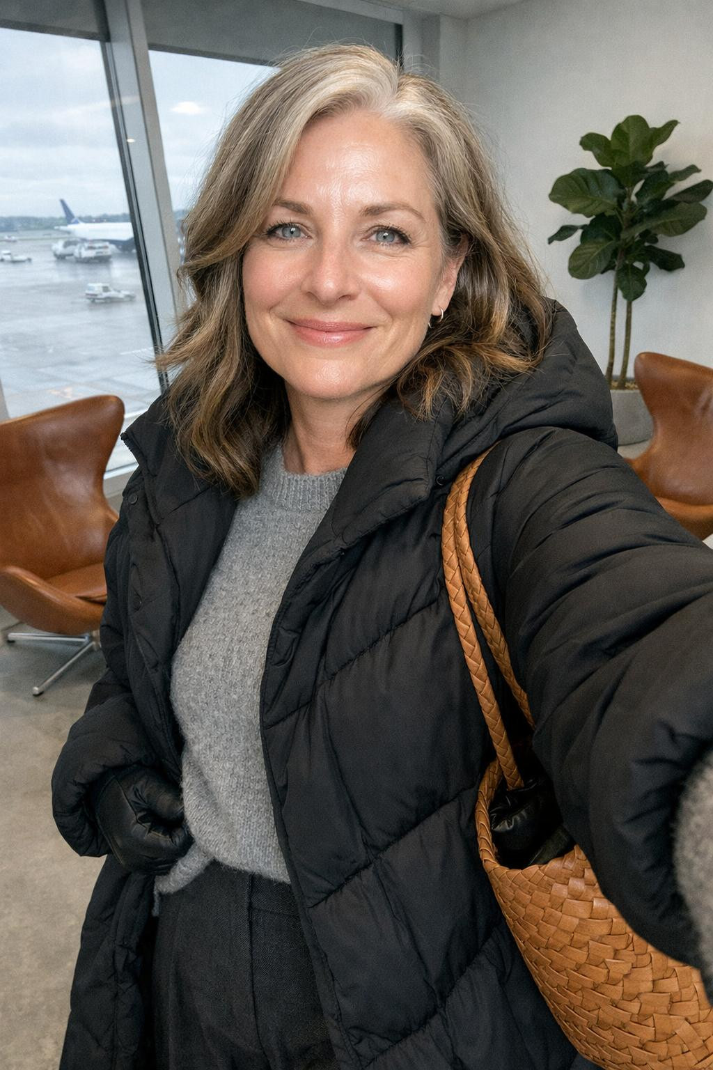Cozy airport outfit front camera selfie in lounge