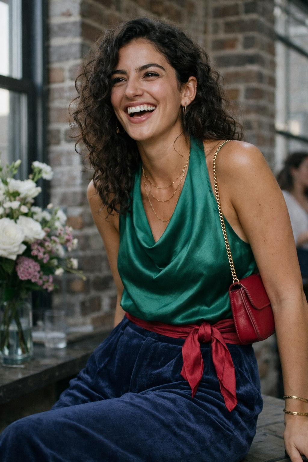 House party outfit with emerald silk halter top and sapphire velvet wide-leg trousers