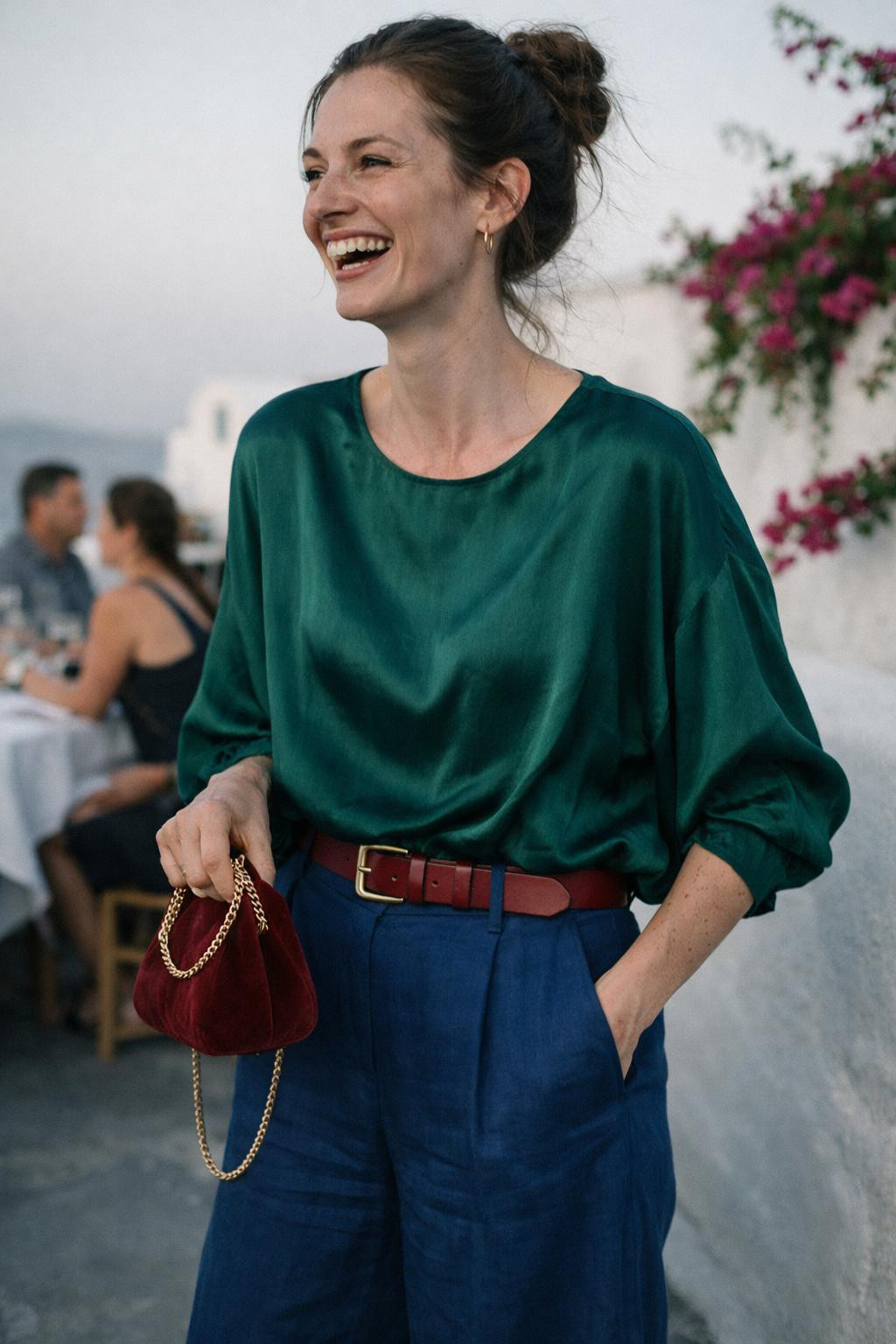 House party outfit with oversized emerald silk blouse and sapphire linen wide-leg trousers