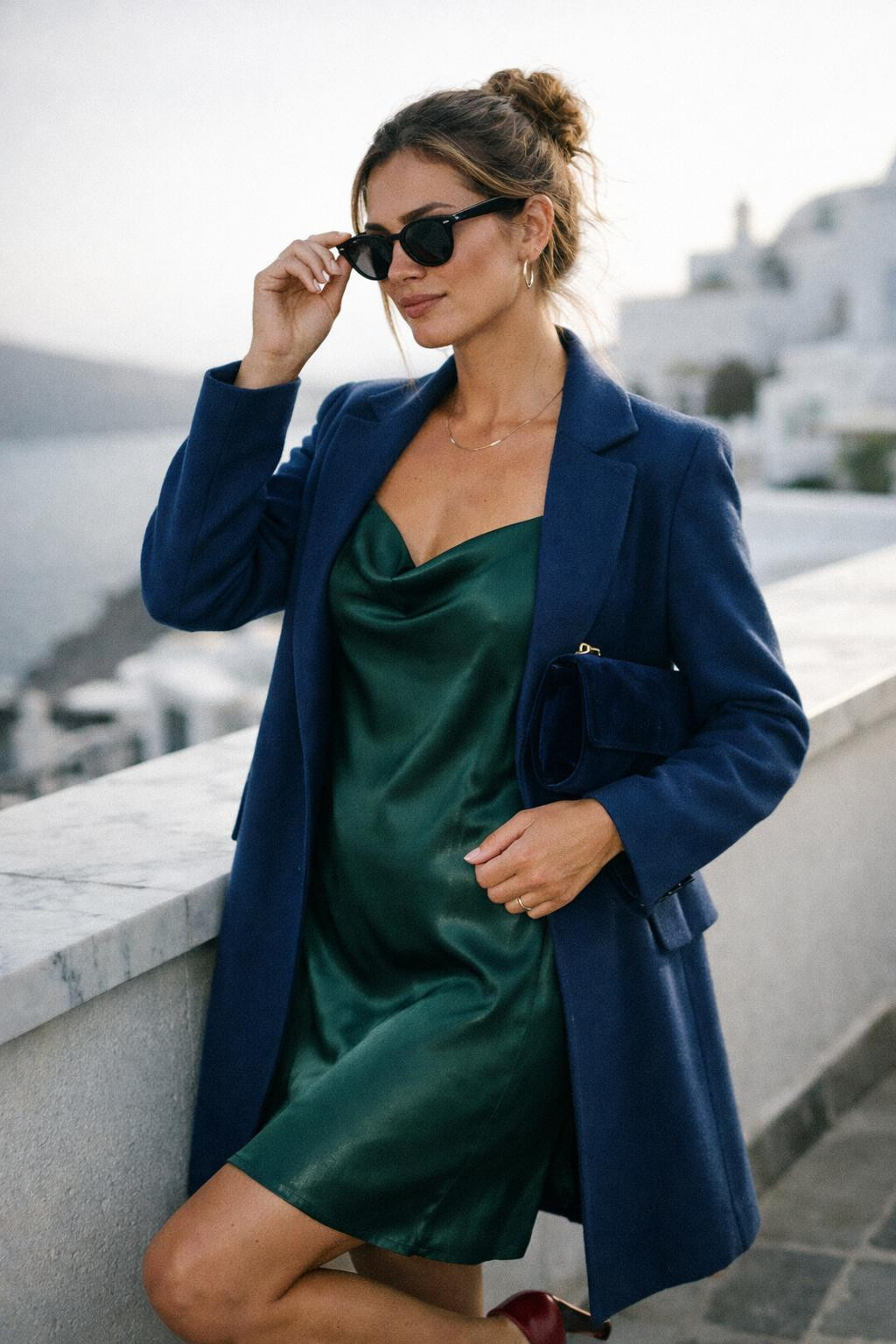 Winter party outfit with minimalist emerald slip and structured coat