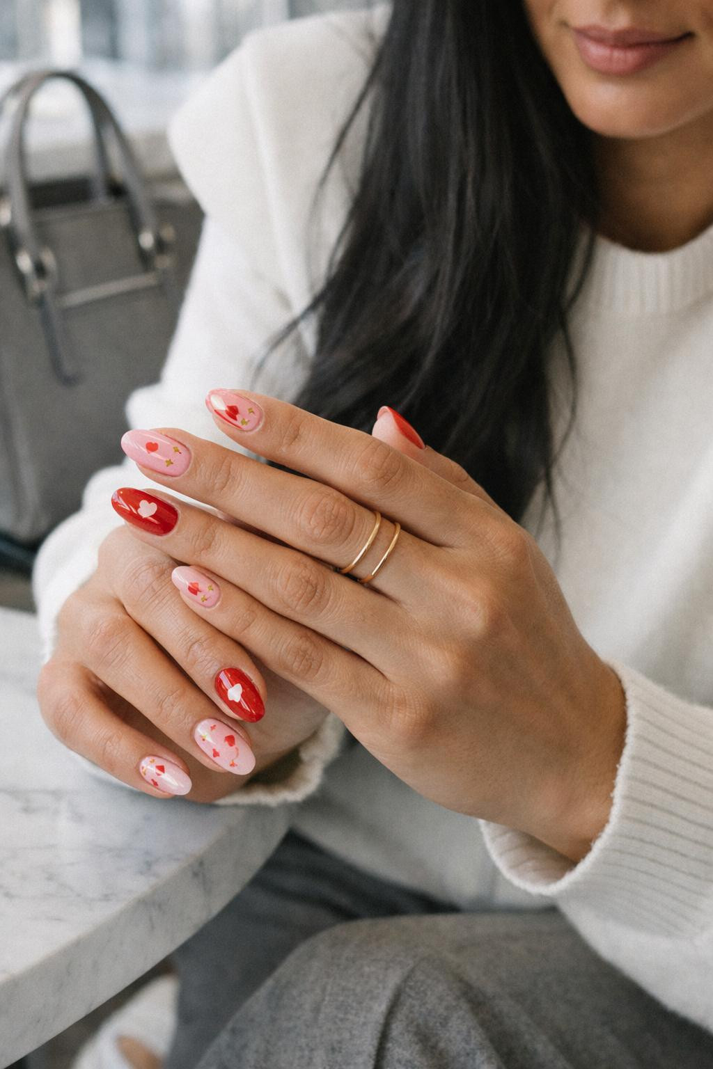 Valentine's Day nails with pink and red gel polish with gold foil accents