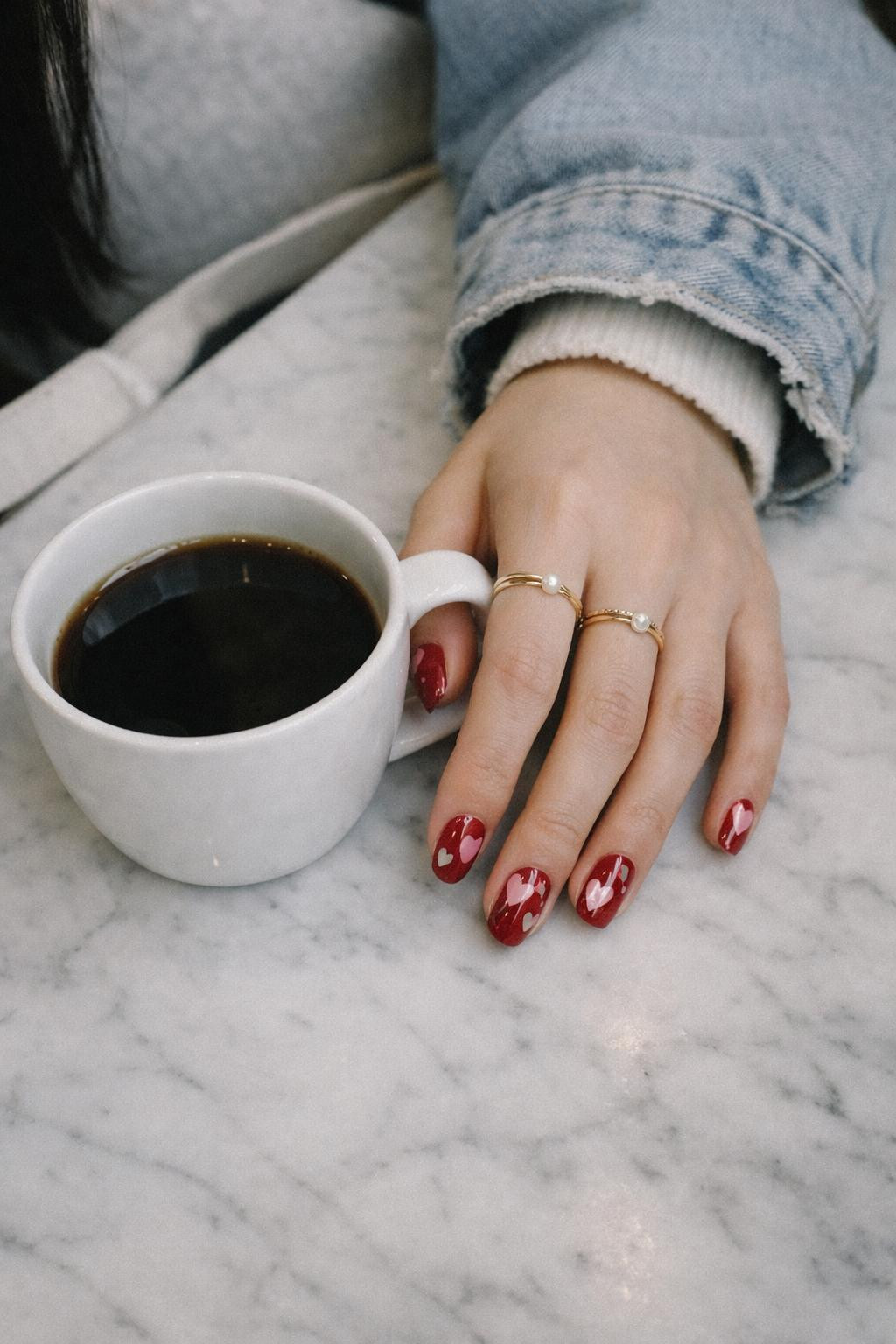Valentine's Day nails with deep romantic red with pink and white heart art