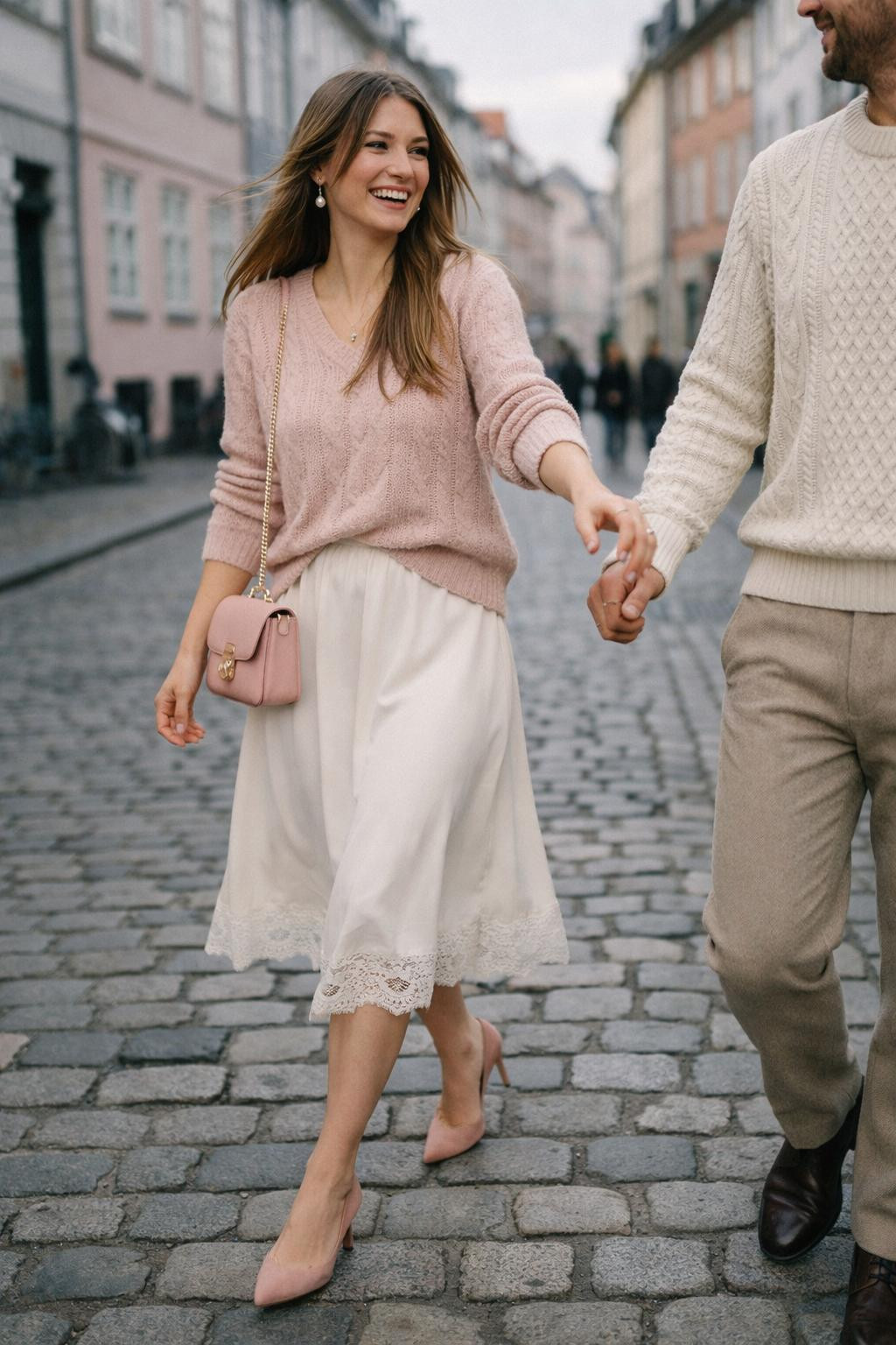 Couples Valentine's outfit with blush cashmere sweater and white silk midi skirt