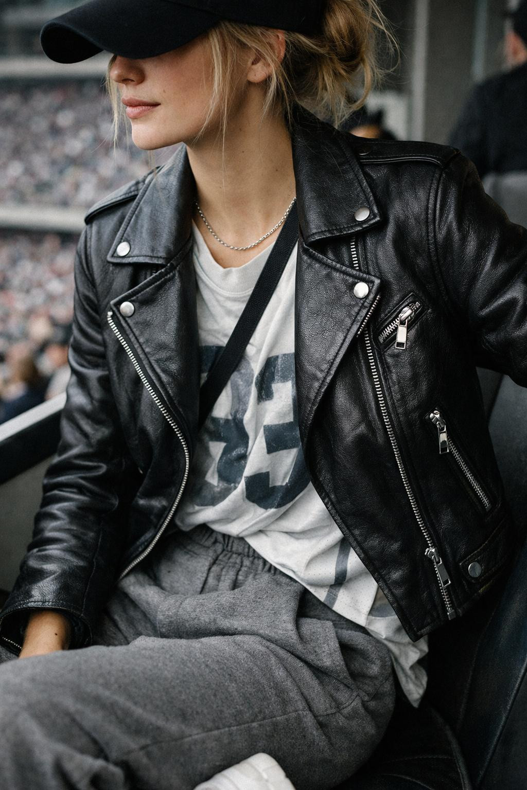 Super Bowl outfit ideas with grey joggers and black leather moto jacket
