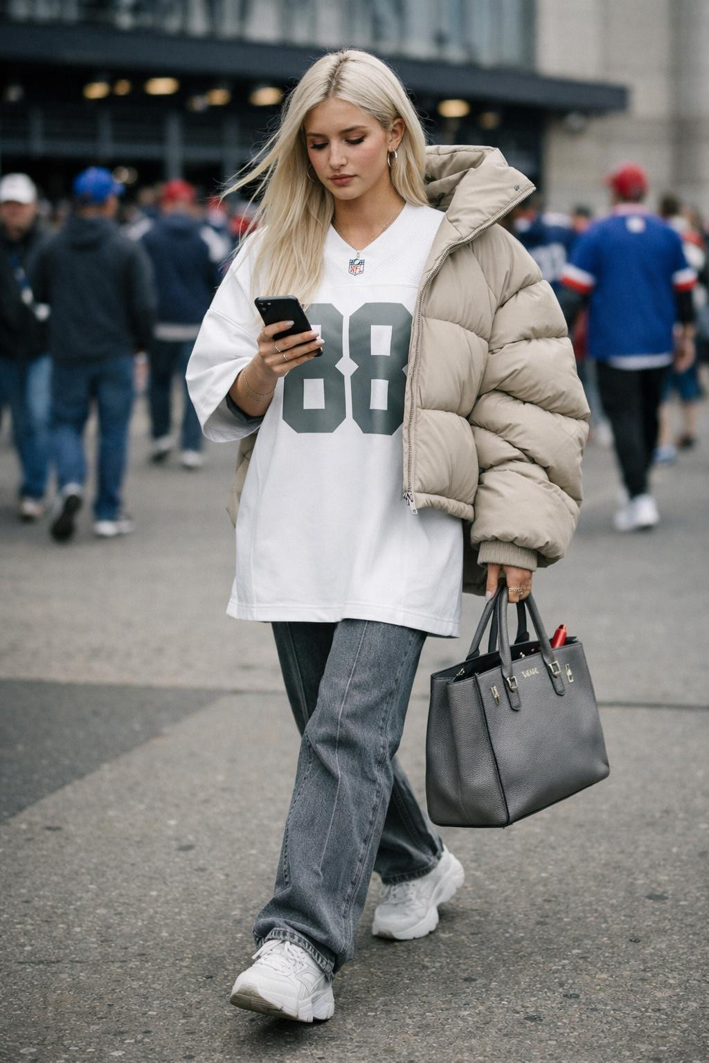 Super Bowl outfit ideas with white jersey and beige sculptural puffer jacket
