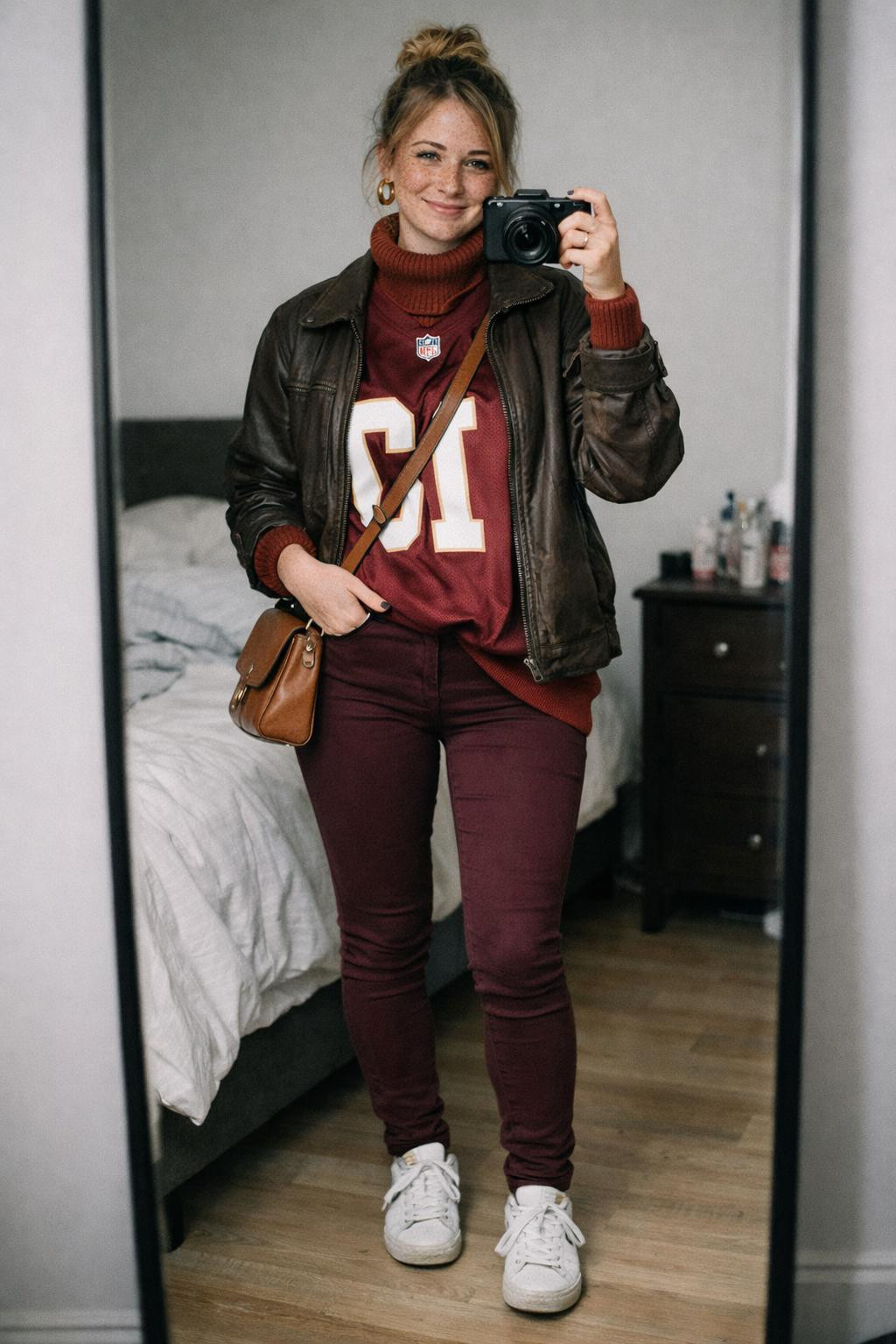 Super Bowl outfit ideas with burgundy jersey and brown leather jacket