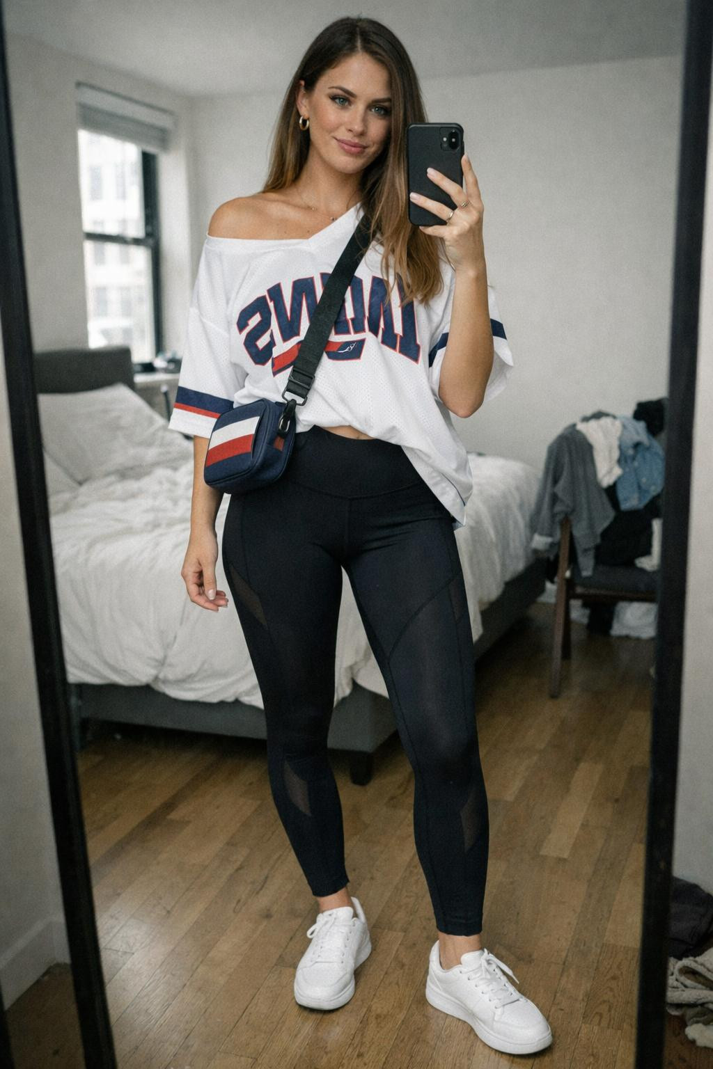 Game day outfit with oversized white jersey over black athletic leggings