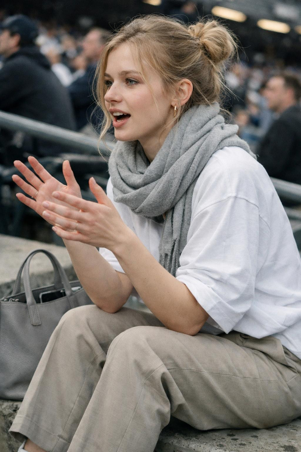 Game day outfit with white oversized jersey and beige tailored wool trousers