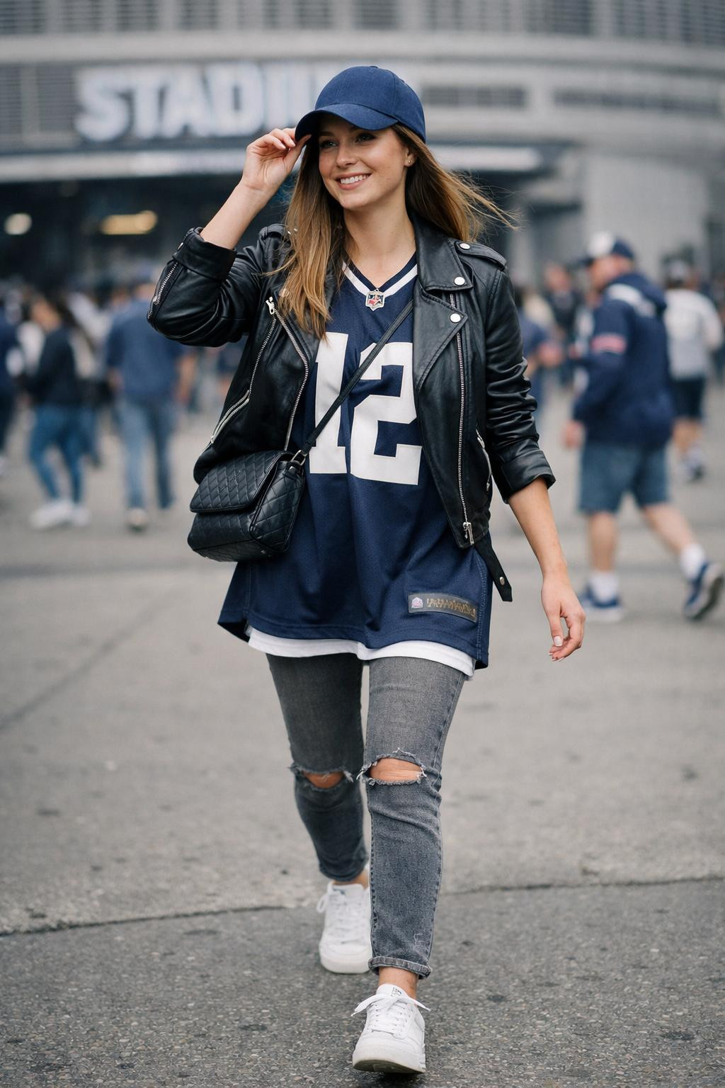 Game day outfit with navy team jersey worn as dress with leather jacket