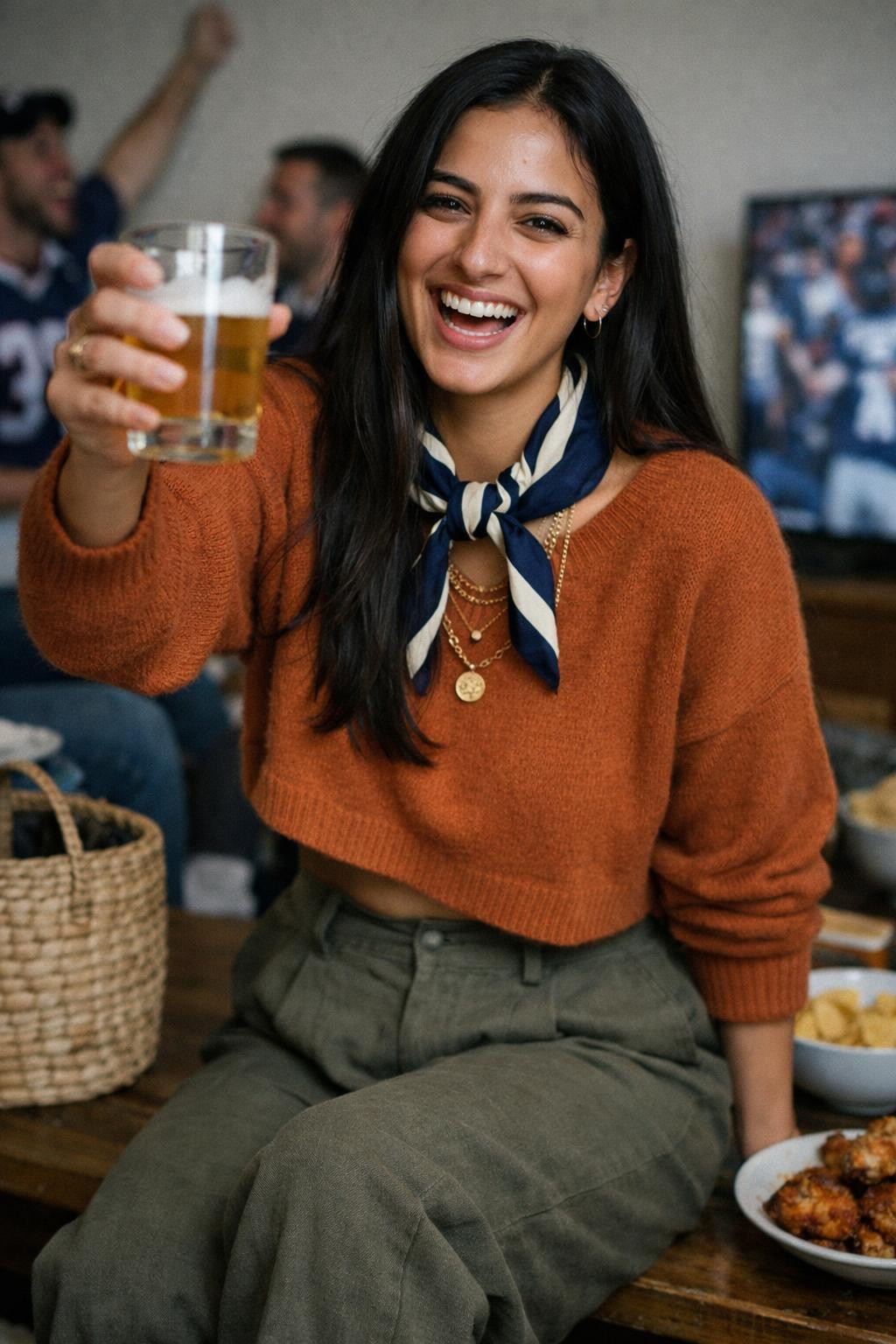 Super Bowl party look with rust orange cashmere sweater and olive pants