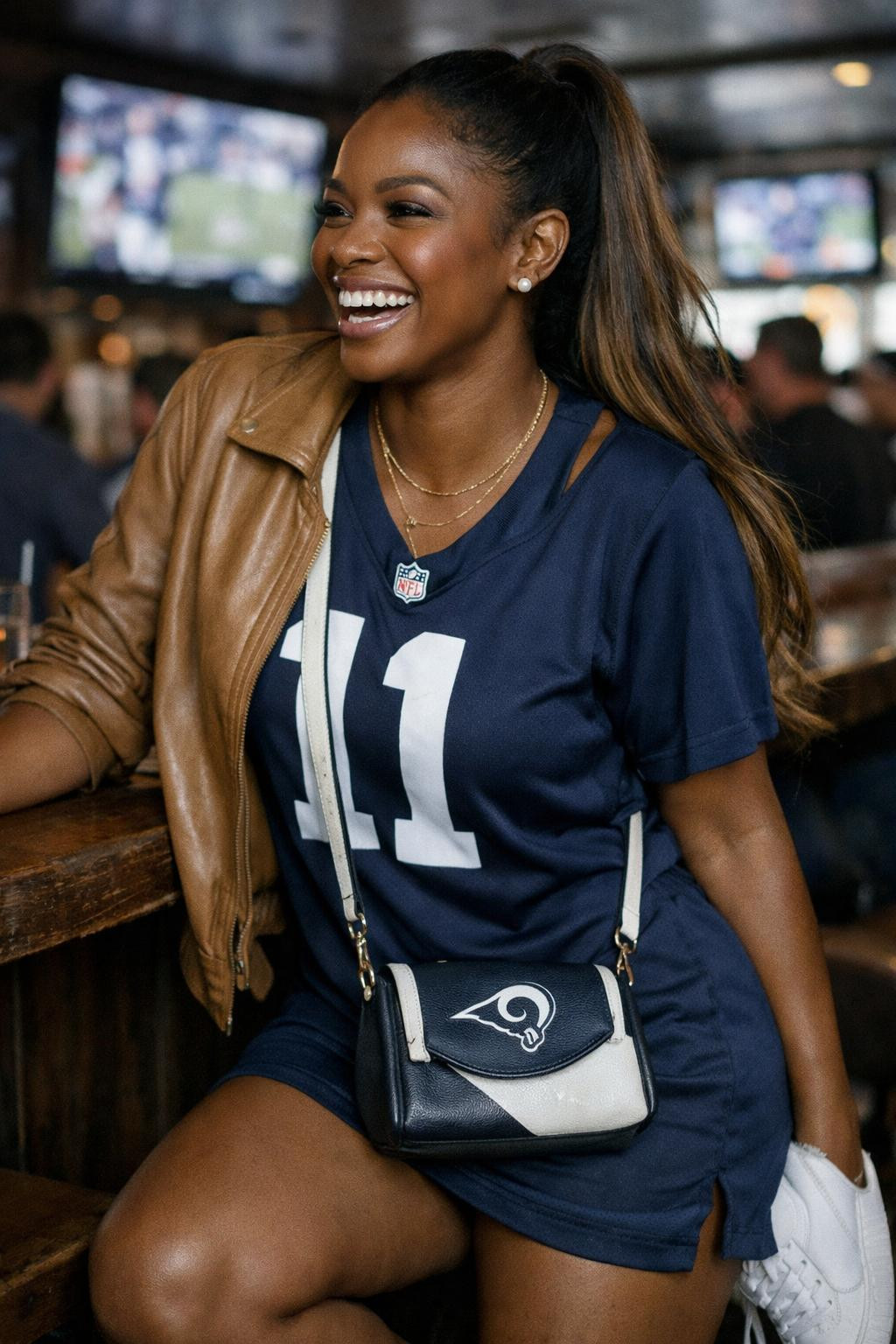 Super Bowl party look with navy jersey dress and camel leather jacket