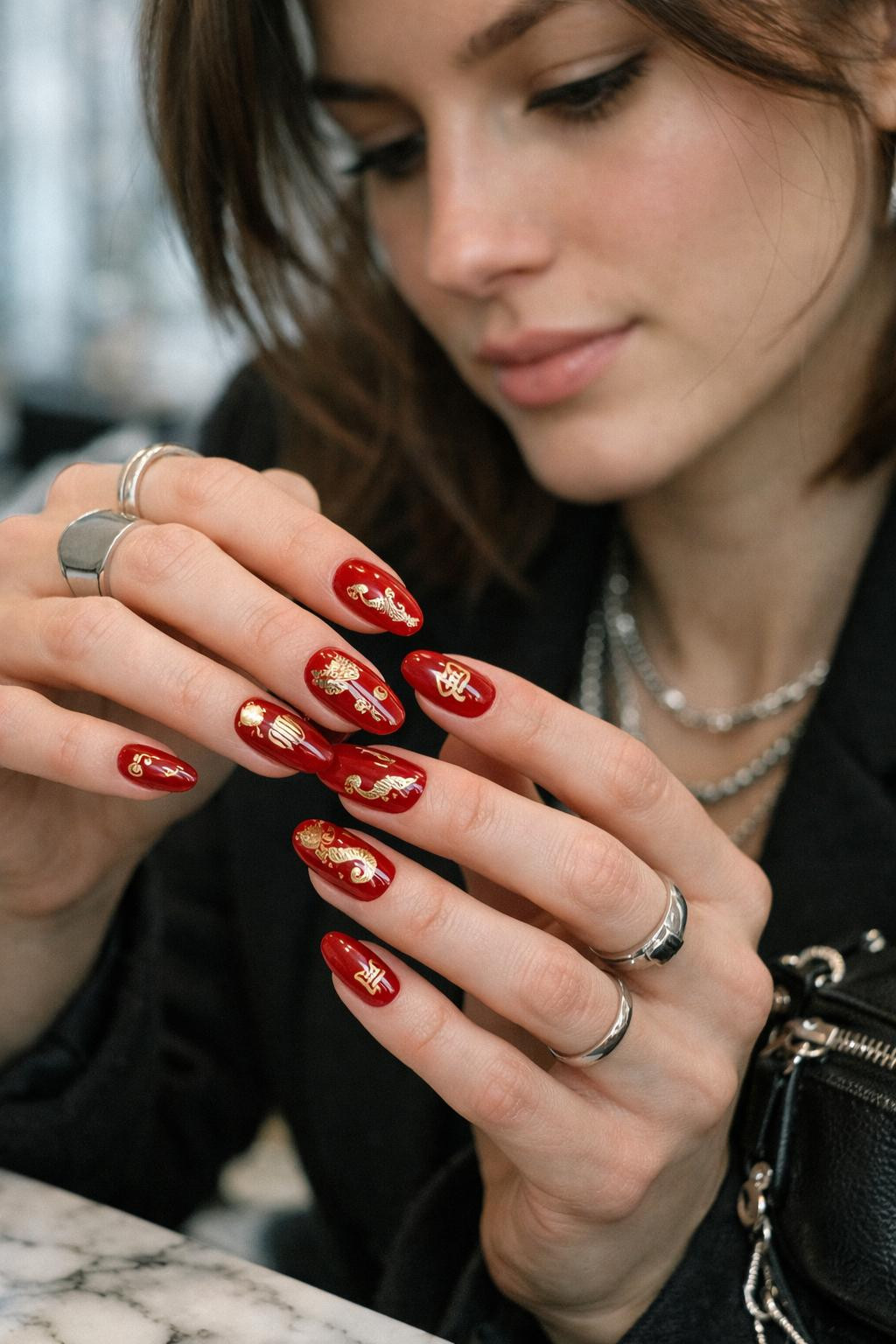 Chinese New Year nails with intricate crimson and gold dragon scales