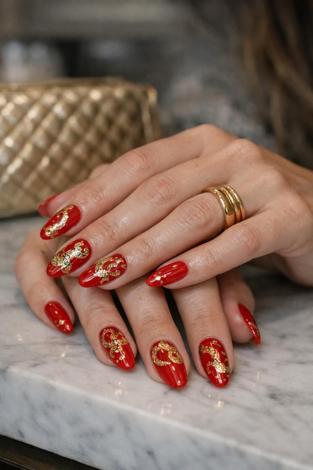 Chinese New Year nails with luxe red gold and lucky coin details