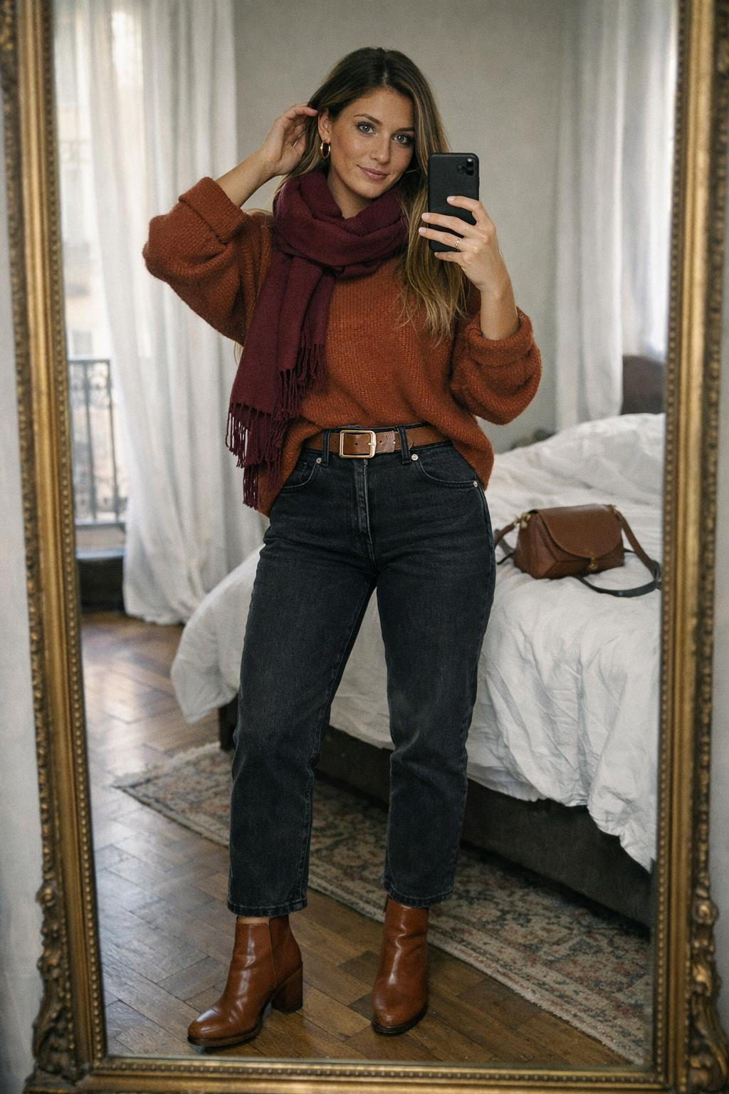 Black jeans outfit with rust cashmere sweater and brown belt