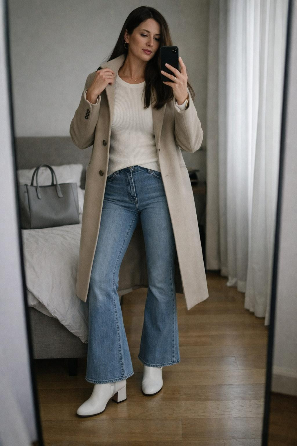 Flare jeans outfit with light wash architectural denim and longline coat