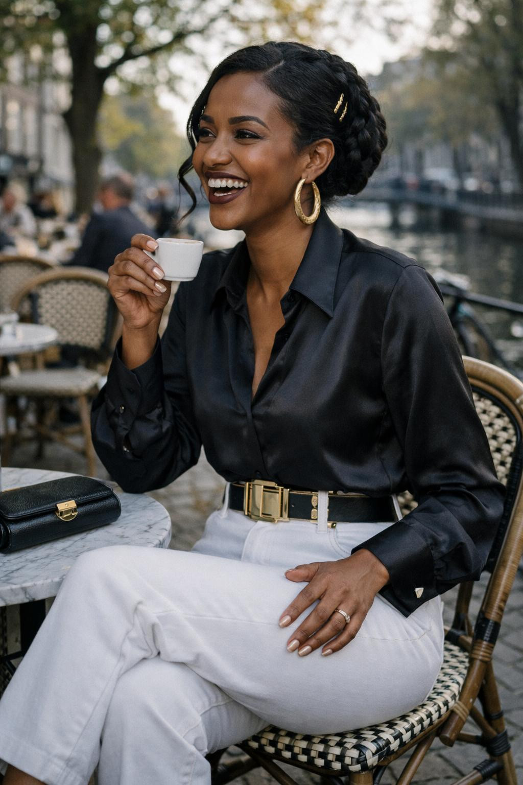 White jeans outfit with black silk blouse and gold statement belt
