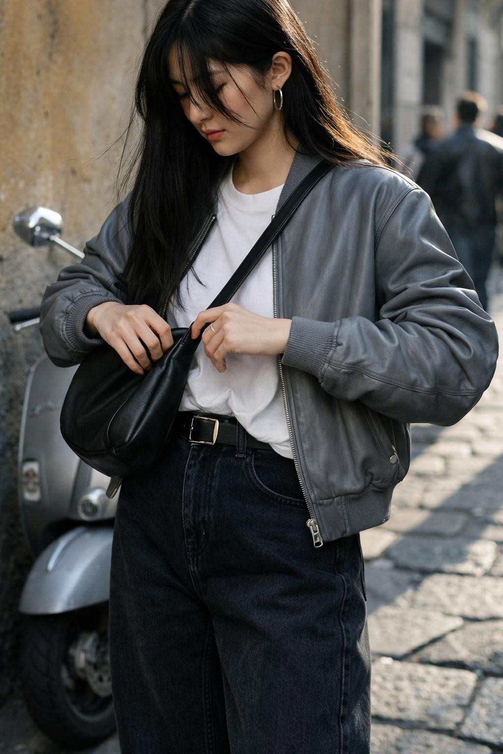 Barrel jeans outfit with black denim and grey leather bomber jacket