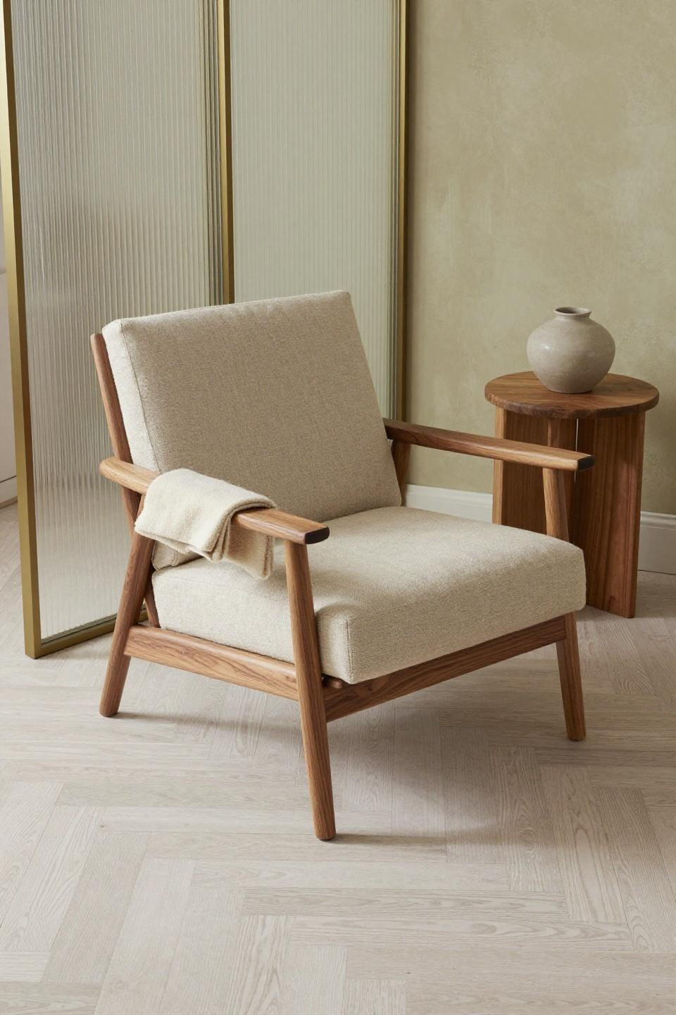 Japandi living room with sculptural walnut lounge chair and herringbone flooring