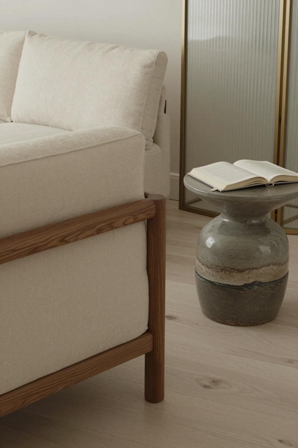 Japandi living room seating with cream linen sofa and walnut armchair