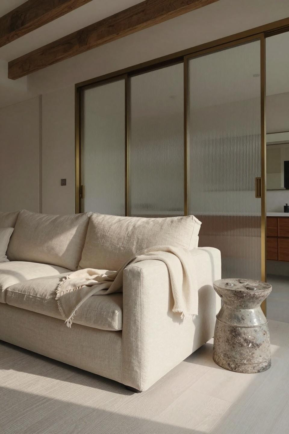 Japandi living room featuring low-profile linen sofa with fluted glass partition