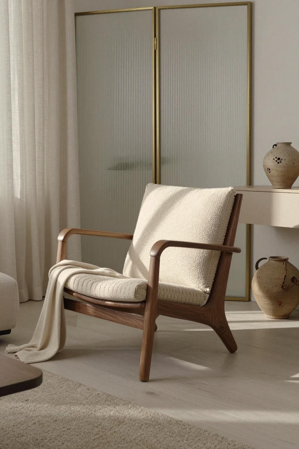Living room with chairs showcasing walnut lounge chair and fluted glass partition