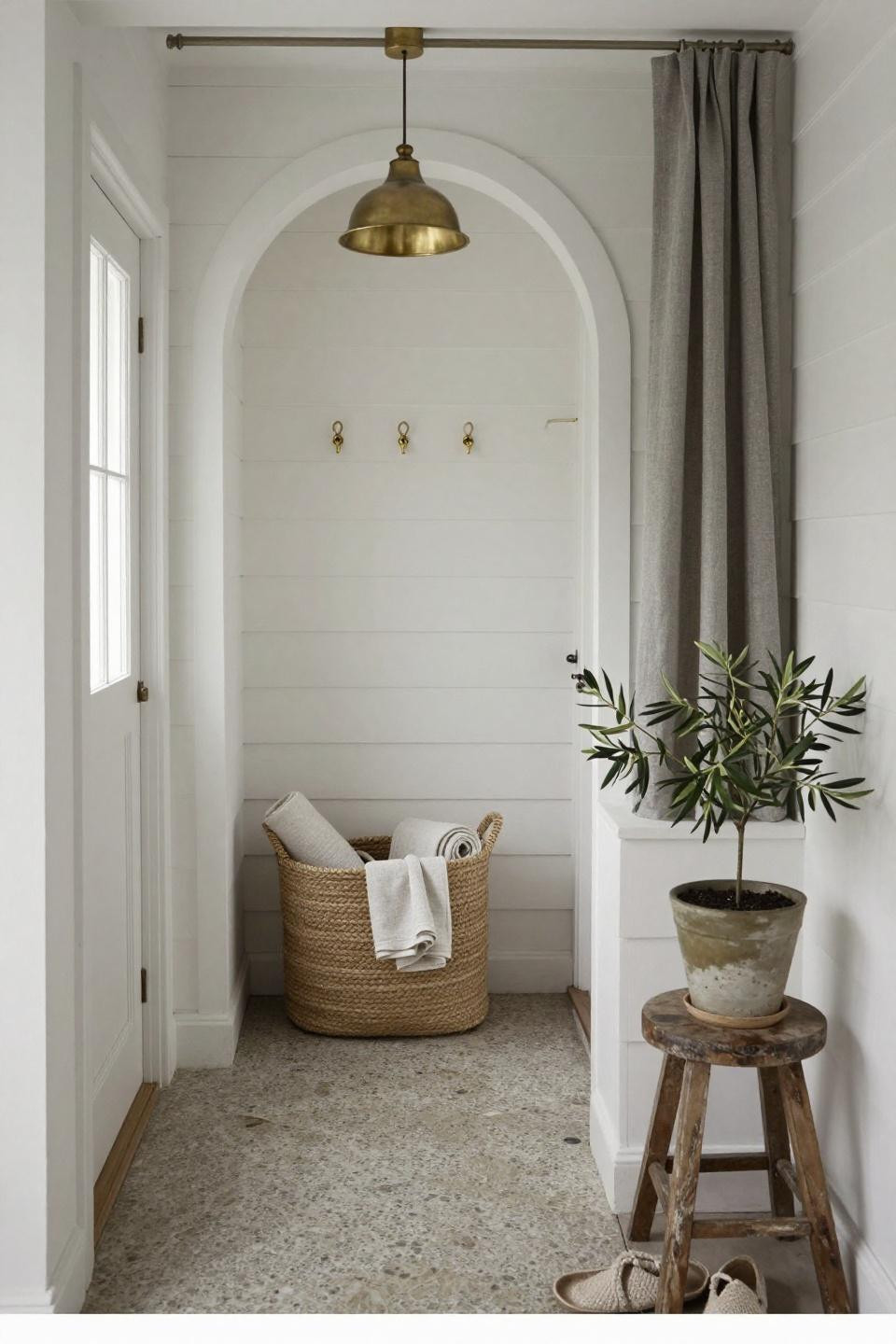 Contemporary cottage entry with white-painted shiplap and arched door